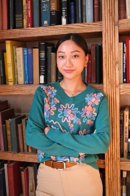 Gail Smith standing in front of a full bookshelf